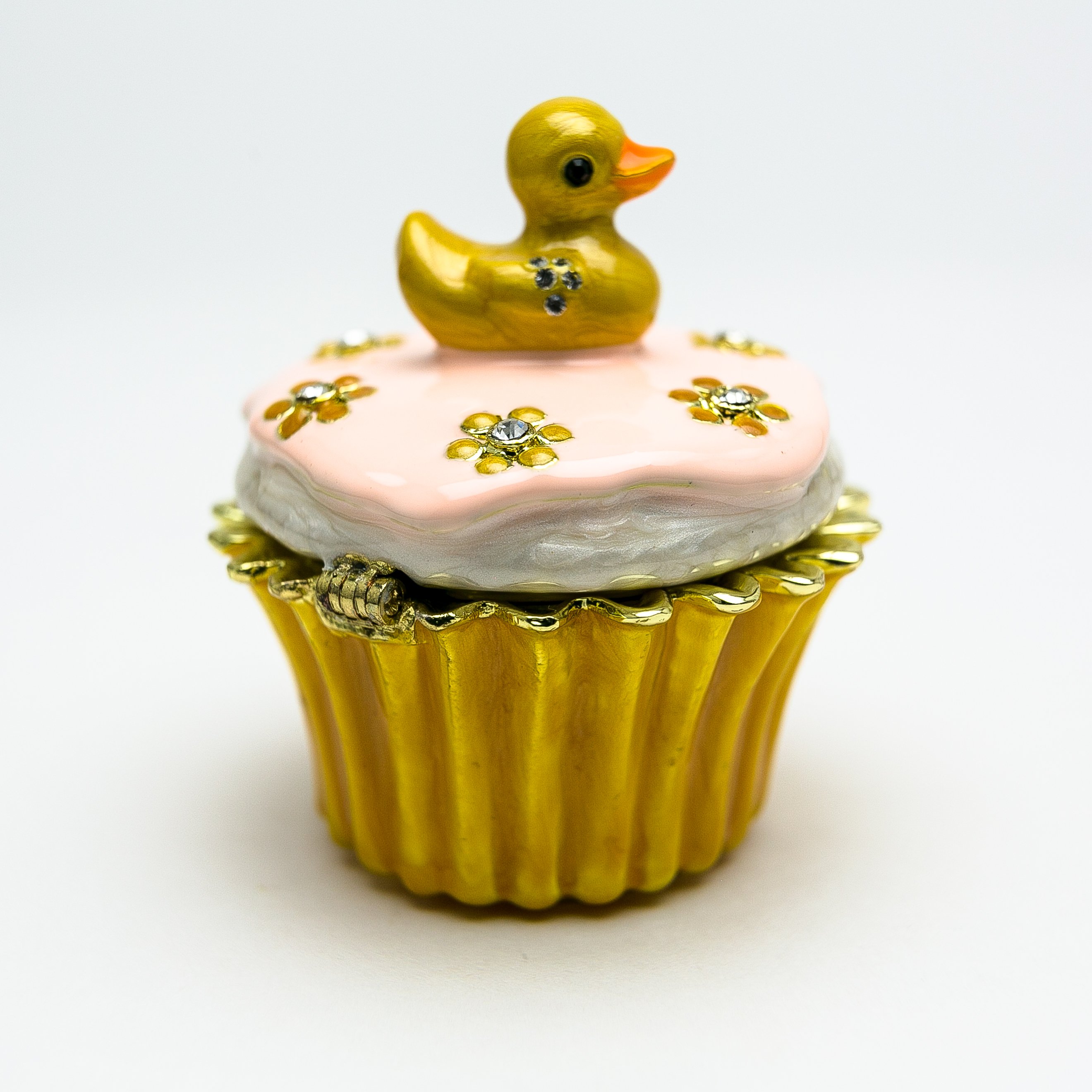 A beautifully handcrafted trinket box featuring a yellow duck on a cupcake, adorned with Austrian crystals and 24K gold plating.