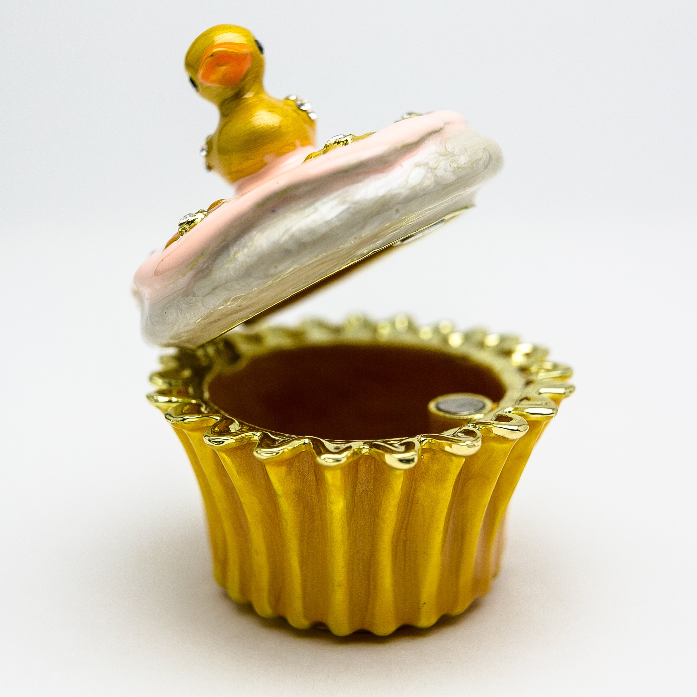 A beautifully handcrafted trinket box featuring a yellow duck on a cupcake, adorned with Austrian crystals and 24K gold plating.