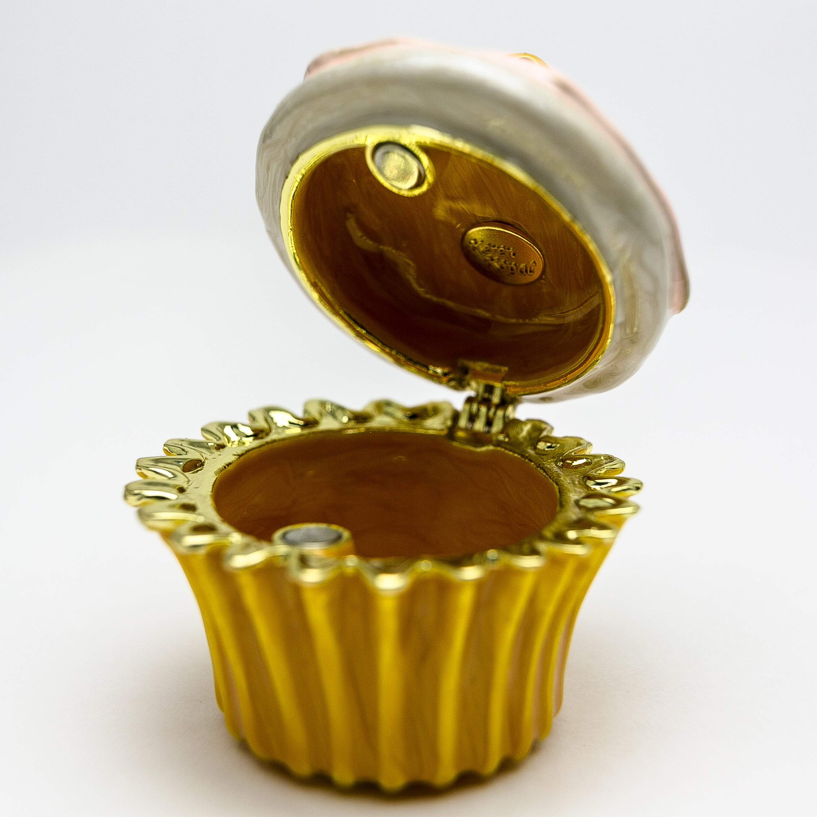 A beautifully handcrafted trinket box featuring a yellow duck on a cupcake, adorned with Austrian crystals and 24K gold plating.