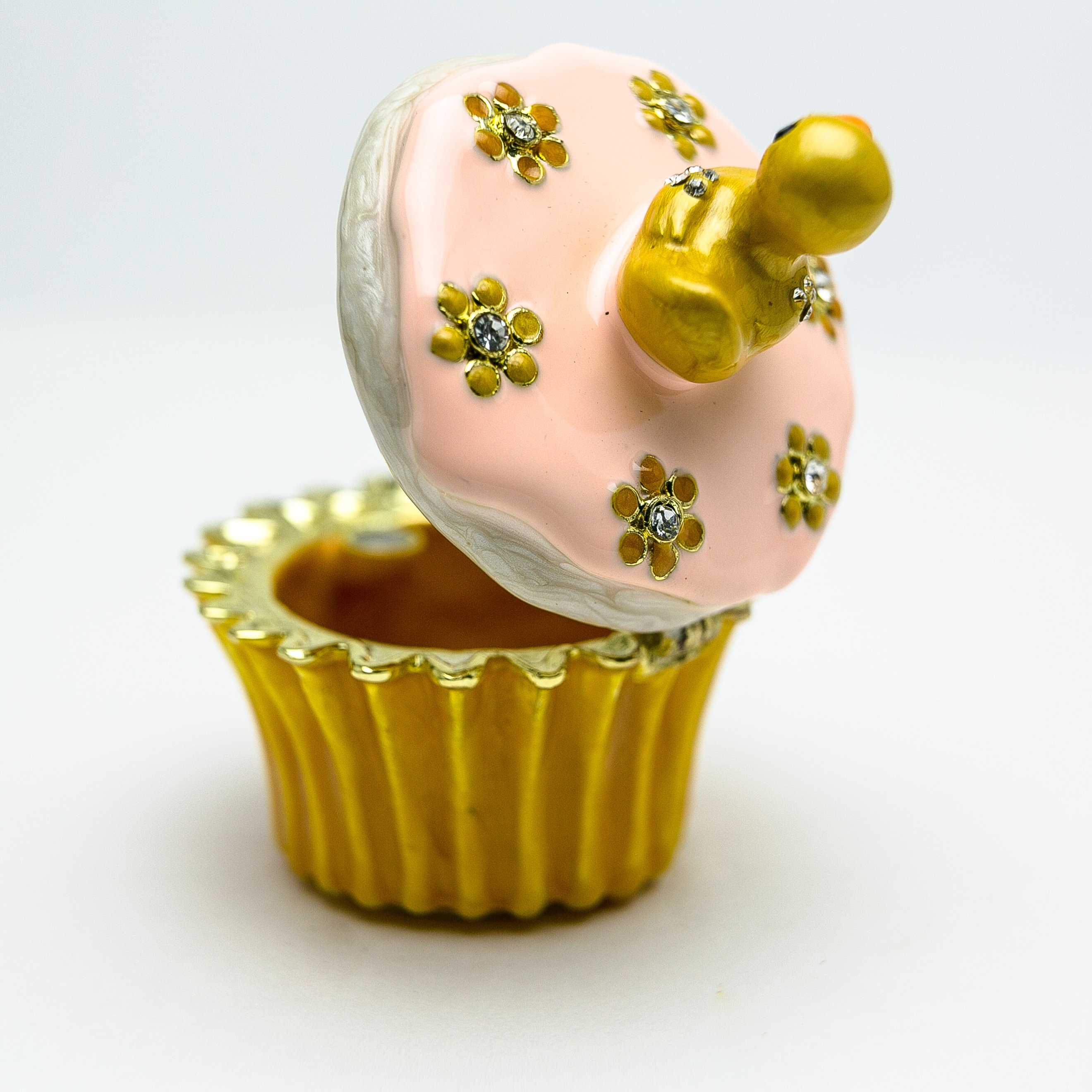 A beautifully handcrafted trinket box featuring a yellow duck on a cupcake, adorned with Austrian crystals and 24K gold plating.