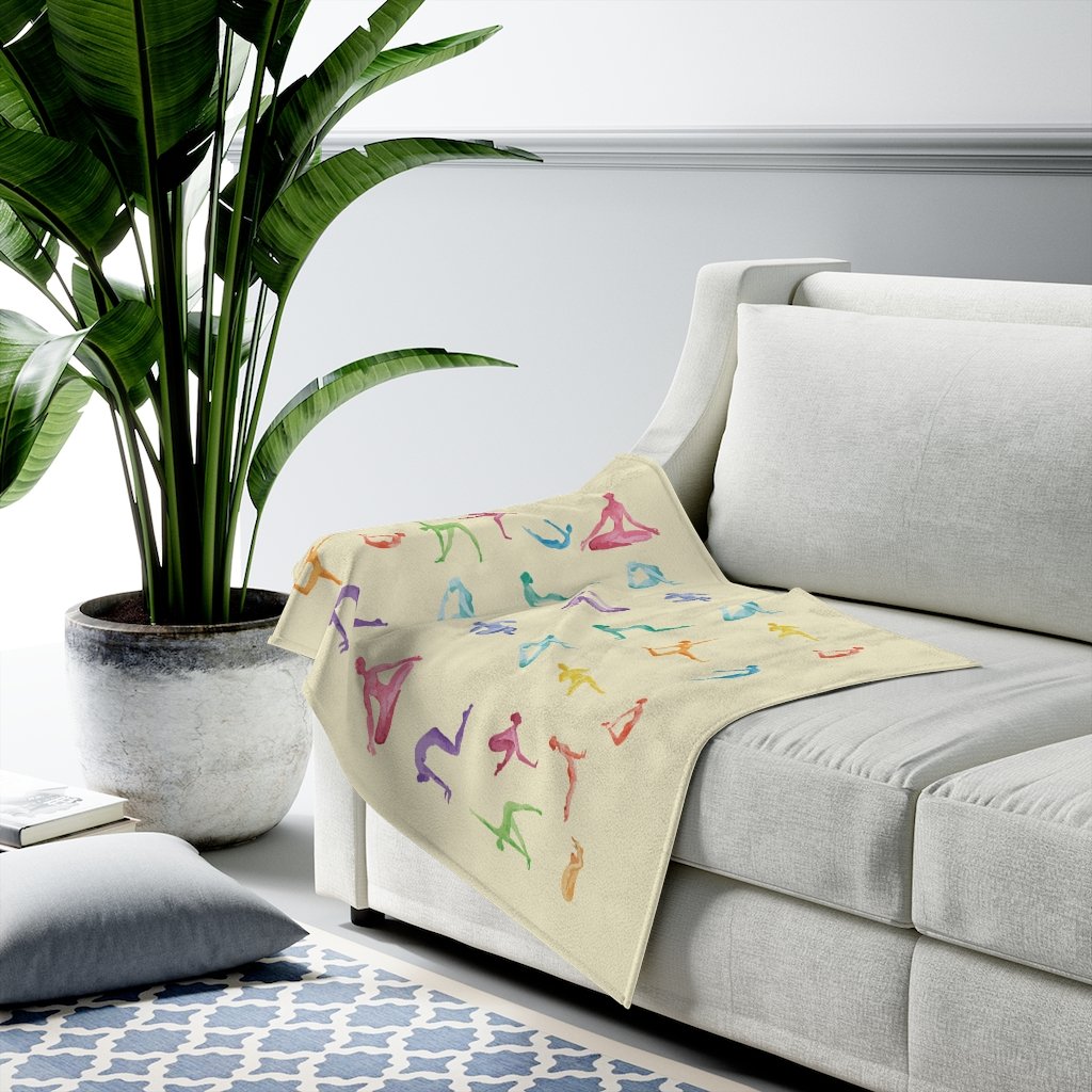 Yoga Sanctuary Velveteen Plush Blanket in a cozy setting, showcasing its soft texture and stylish design.