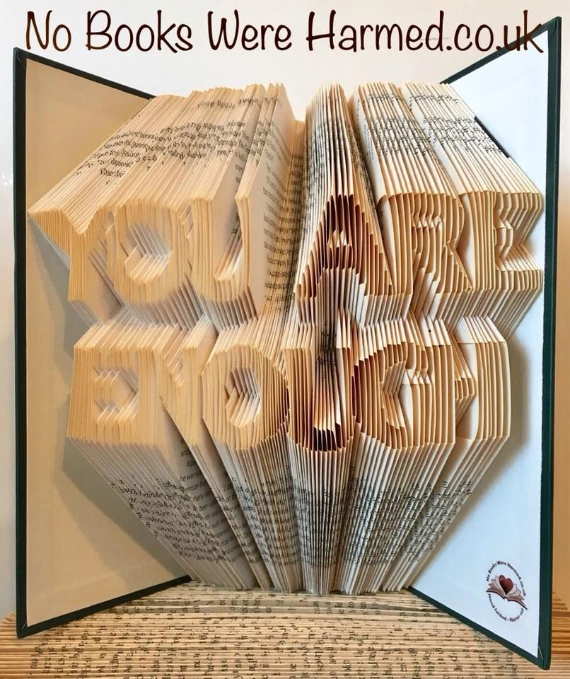 A beautifully handcrafted book art piece titled 'You are Enough', made from vintage book pages, showcasing intricate hand-folded designs.