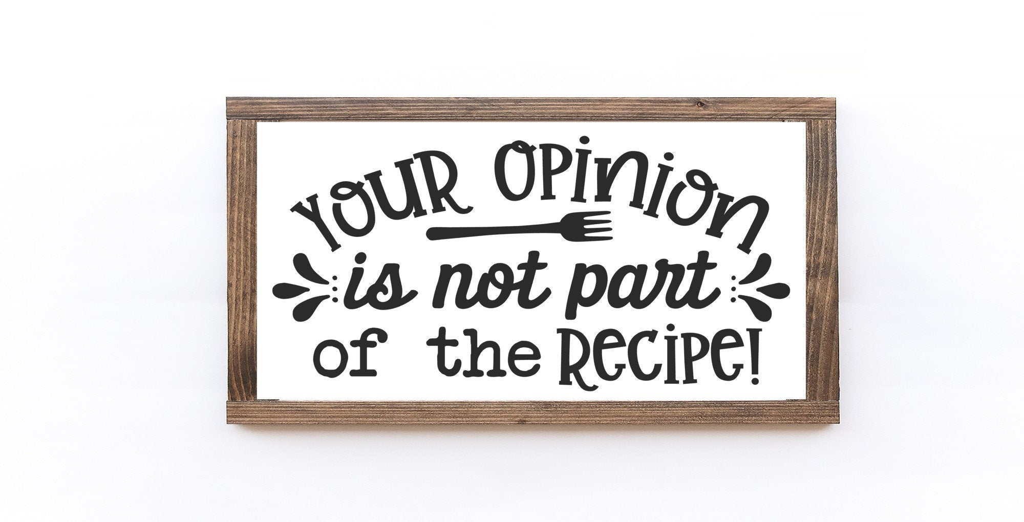 A rustic wooden sign with the phrase 'Your Opinion Is Not Part Of The Recipe' painted in black on a matte white background, showcasing its handmade quality.