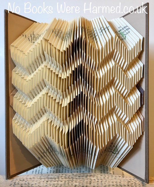 Zig Zag art piece handcrafted from vintage books, showcasing intricate folds and unique design.