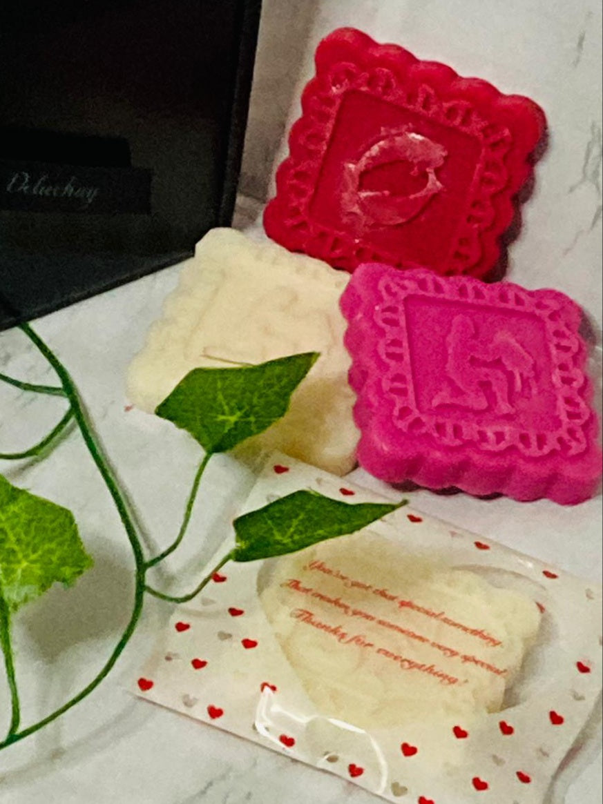 A collection of Zodiac birthday sign wax melts in square blocks, showcasing various colors and scents, perfect for gifting.