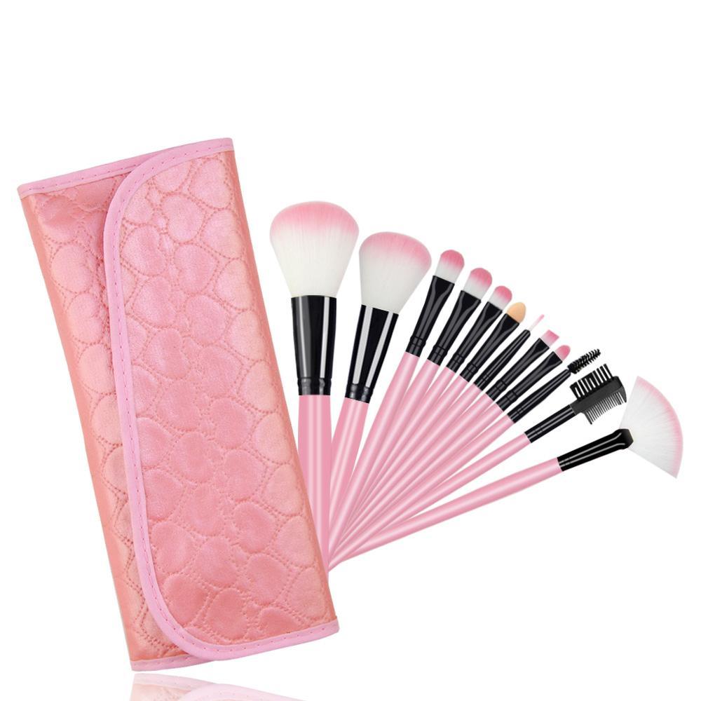 A set of 12 professional makeup brushes with wooden handles and vegan-friendly bristles, displayed in a stylish carrying bag.