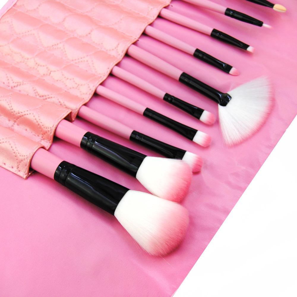 A set of 12 professional makeup brushes with wooden handles and vegan-friendly bristles, displayed in a stylish carrying bag.