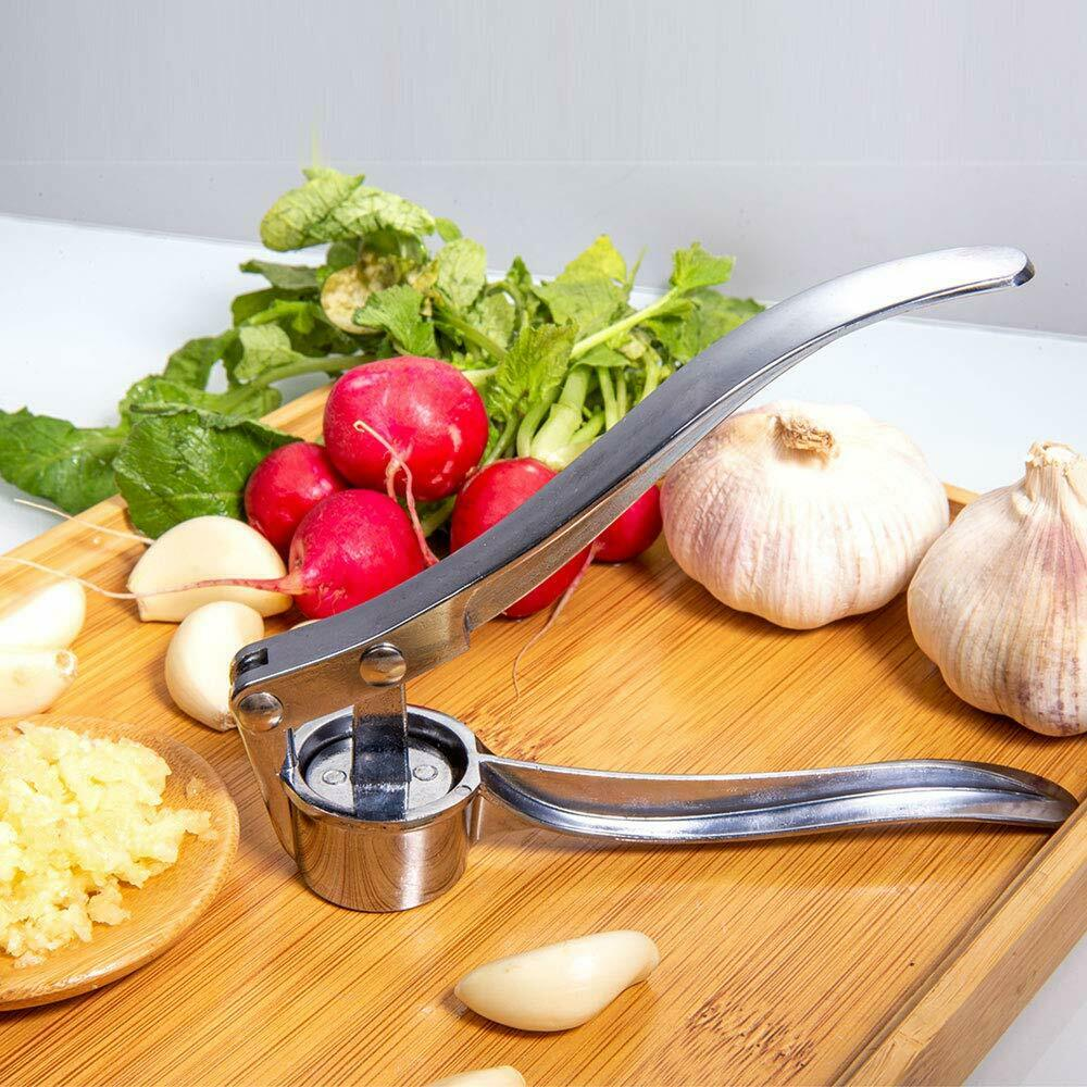 Heavy-duty stainless steel garlic press with ergonomic design, showcasing its durable zinc alloy construction and large cabin for multiple cloves.