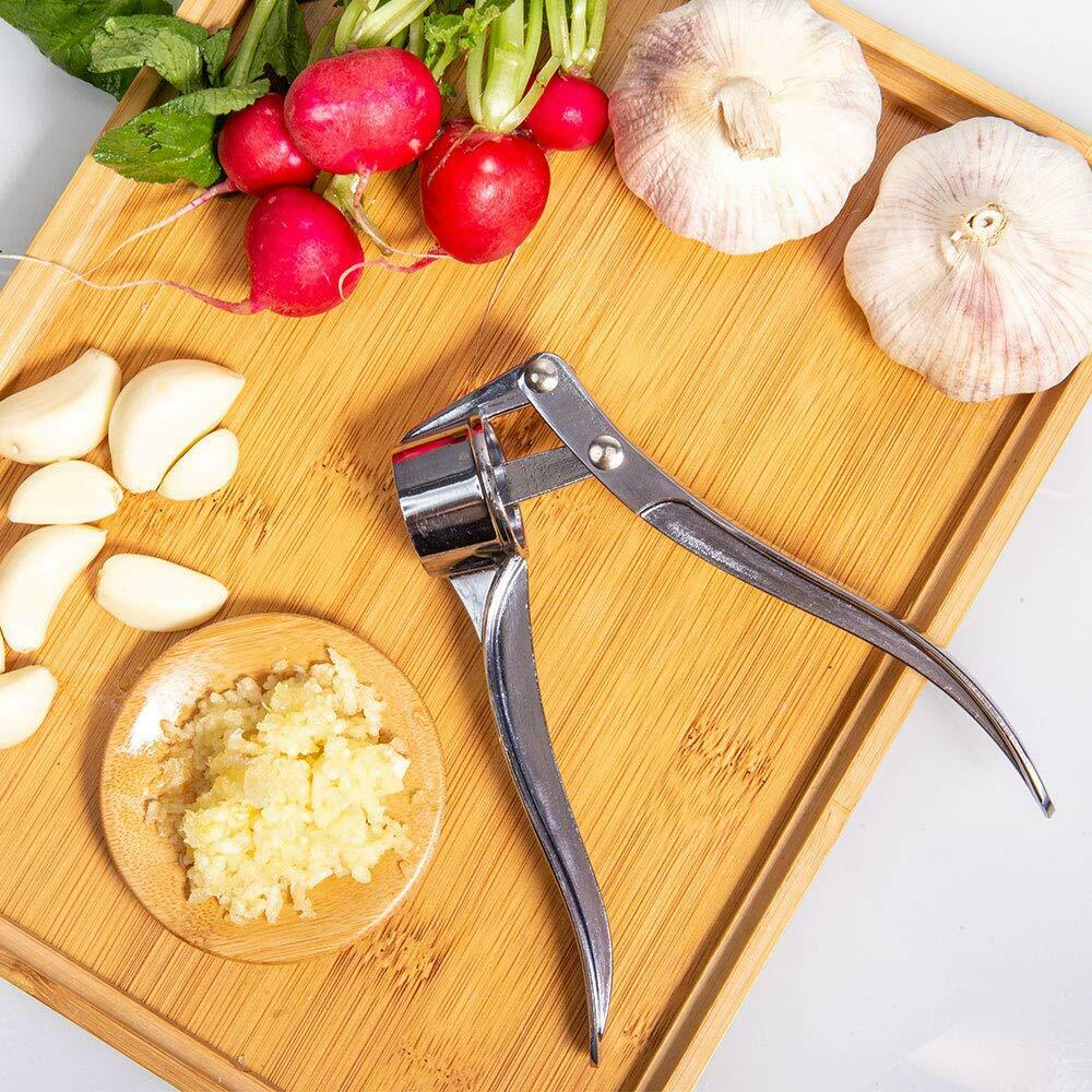 Heavy-duty stainless steel garlic press with ergonomic design, showcasing its durable zinc alloy construction and large cabin for multiple cloves.