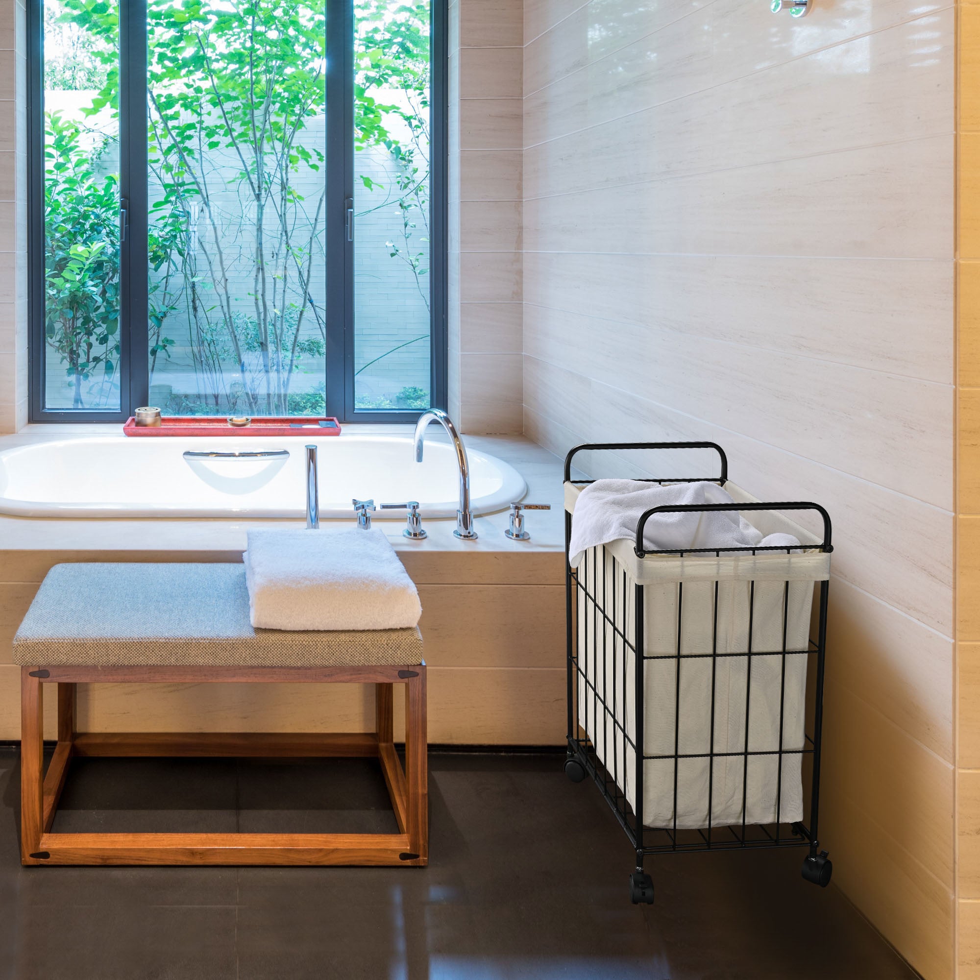 Aquaterior Laundry Hamper with rolling wheels, featuring a black iron wire frame and white canvas bag, perfect for stylish laundry storage.