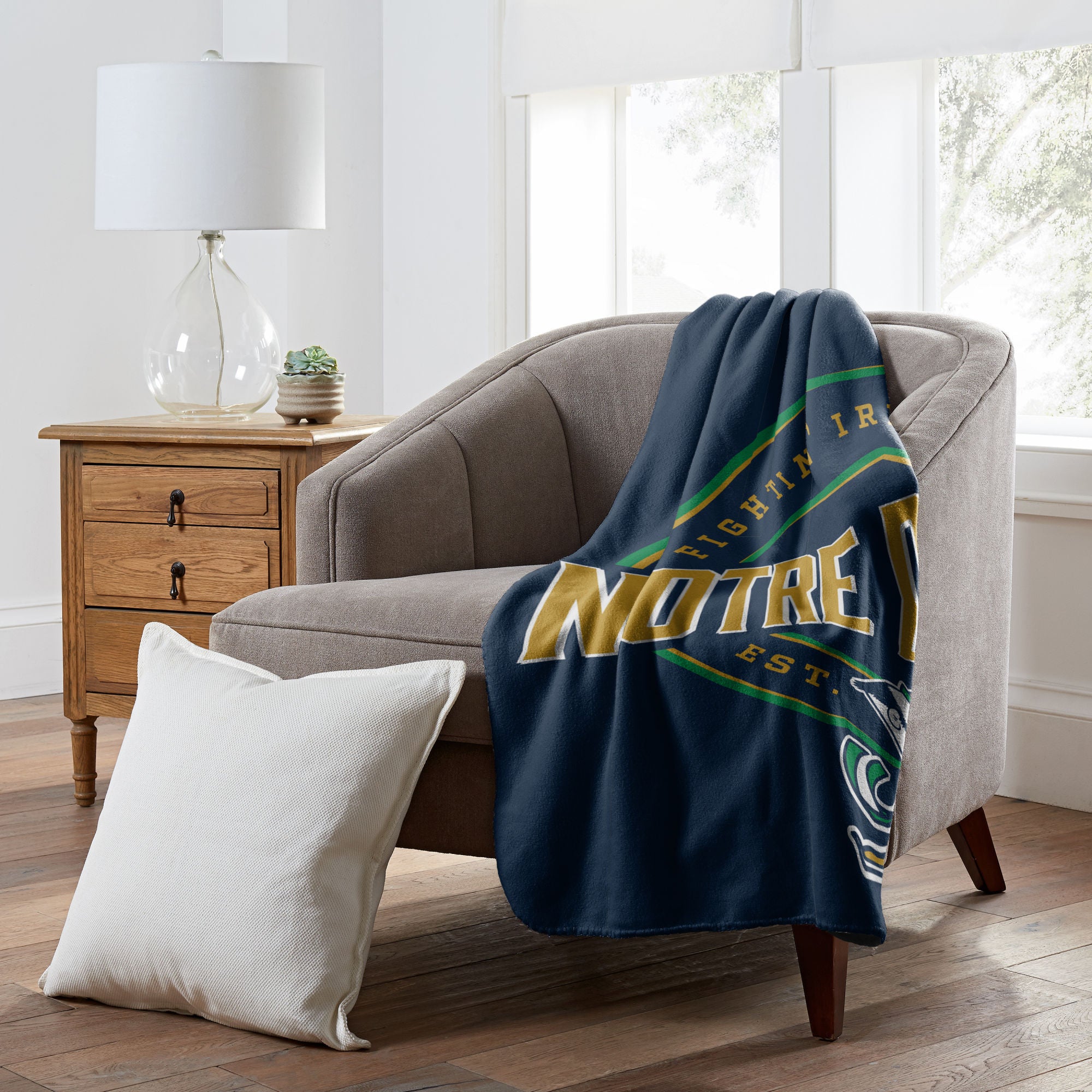 Notre Dame NCAA fleece throw blanket featuring team name and logo in bold design, measuring 50x60 inches.