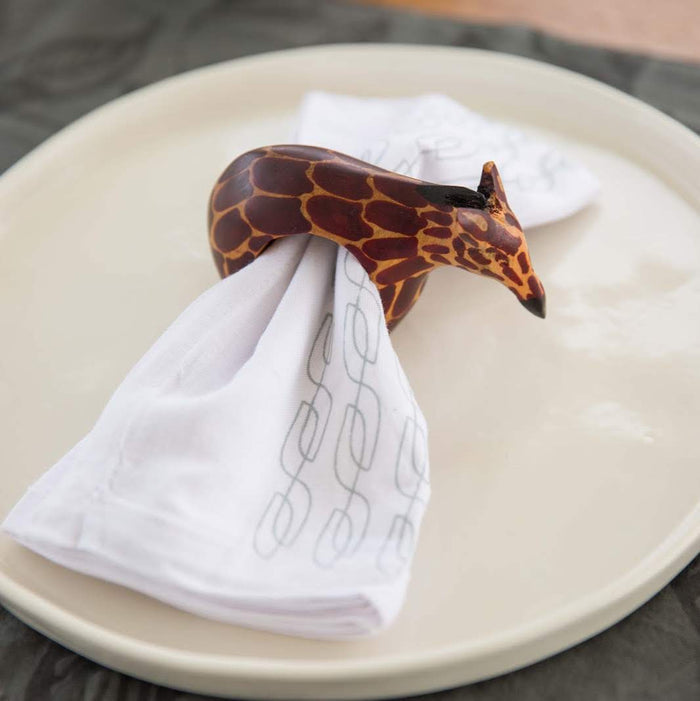 Set of six hand-carved African wooden napkin rings featuring giraffe, elephant, cheetah, zebra, rhino, and lion designs.