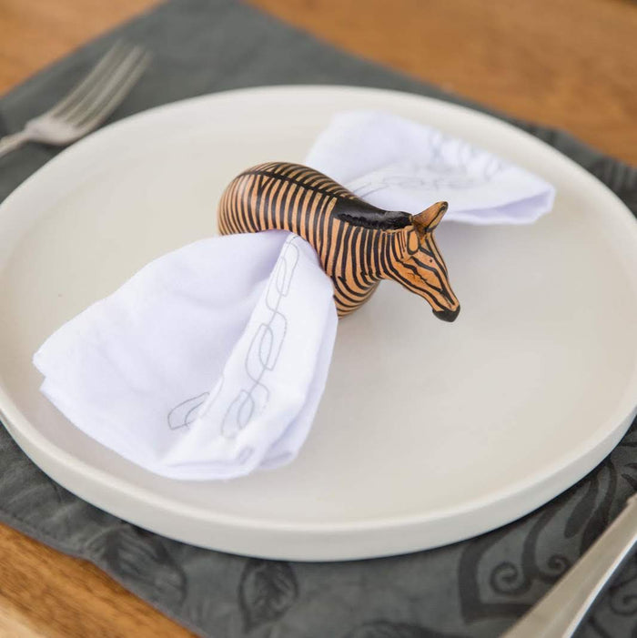 Set of six hand-carved African wooden napkin rings featuring giraffe, elephant, cheetah, zebra, rhino, and lion designs.