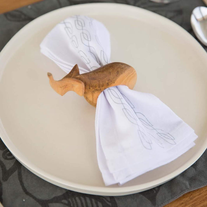 Set of six hand-carved African wooden napkin rings featuring giraffe, elephant, cheetah, zebra, rhino, and lion designs.