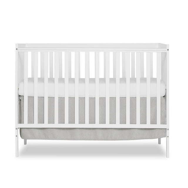 Synergy 5-in-1 Convertible Crib in white, showcasing its classic design and solid pine wood construction.