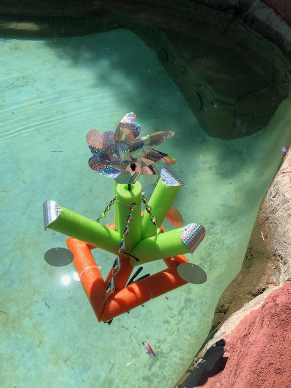 TBA Pool Deterrent holographic floatie designed to keep birds away from pools, ponds, and boats, featuring a colorful reflective surface.