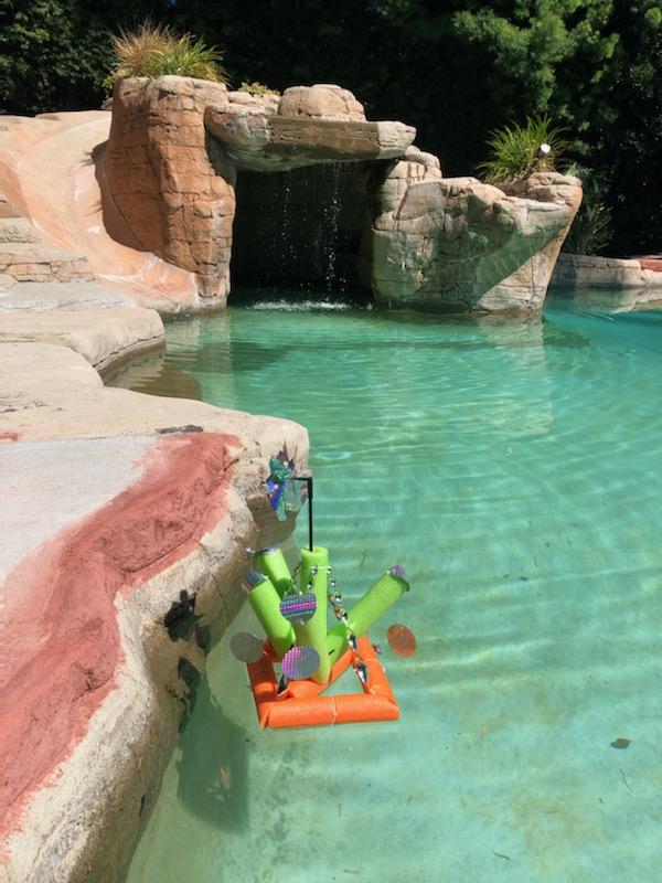 TBA Pool Deterrent holographic floatie designed to keep birds away from pools, ponds, and boats, featuring a colorful reflective surface.