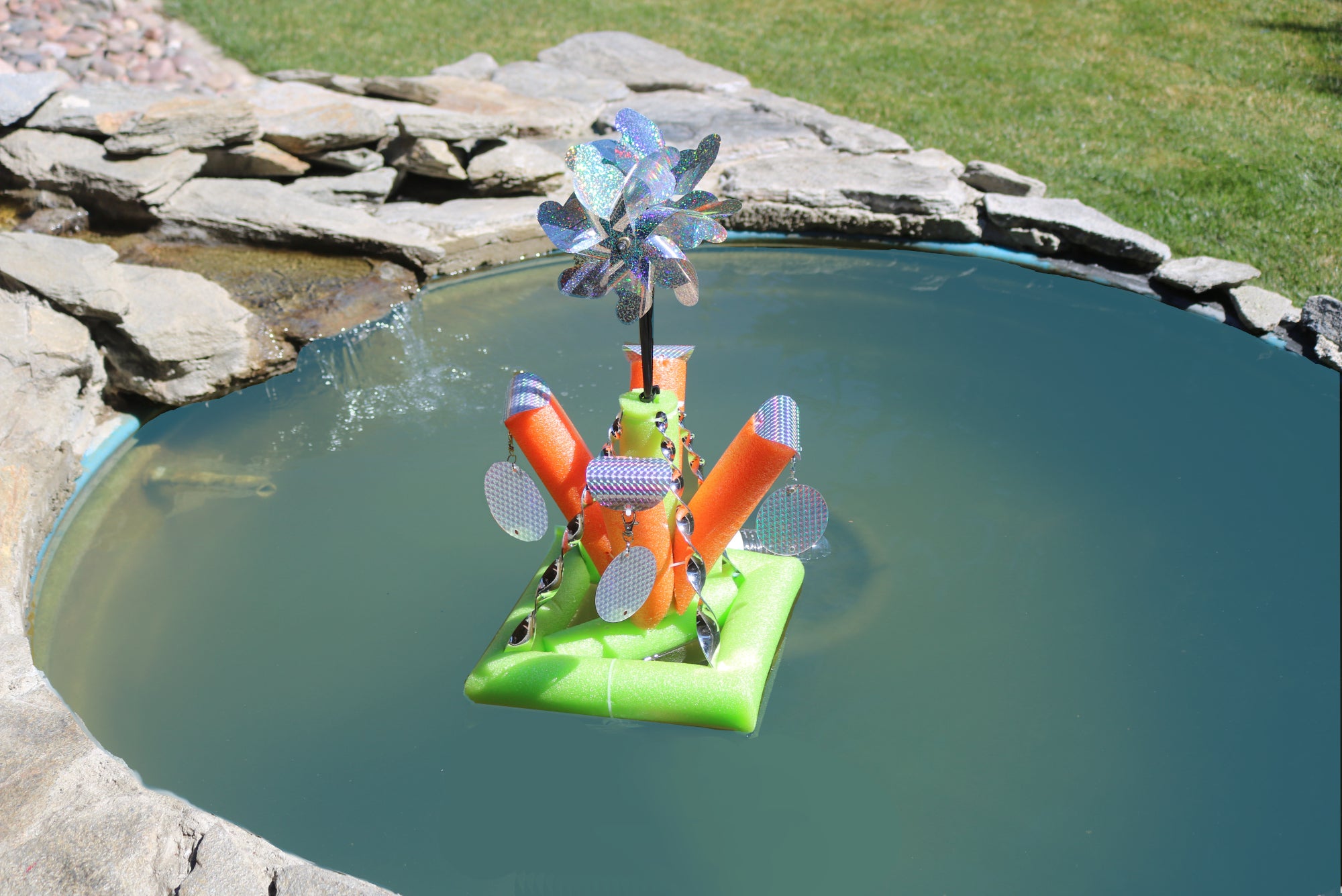 TBA Pool Deterrent holographic floatie designed to keep birds away from pools, ponds, and boats, featuring a colorful reflective surface.