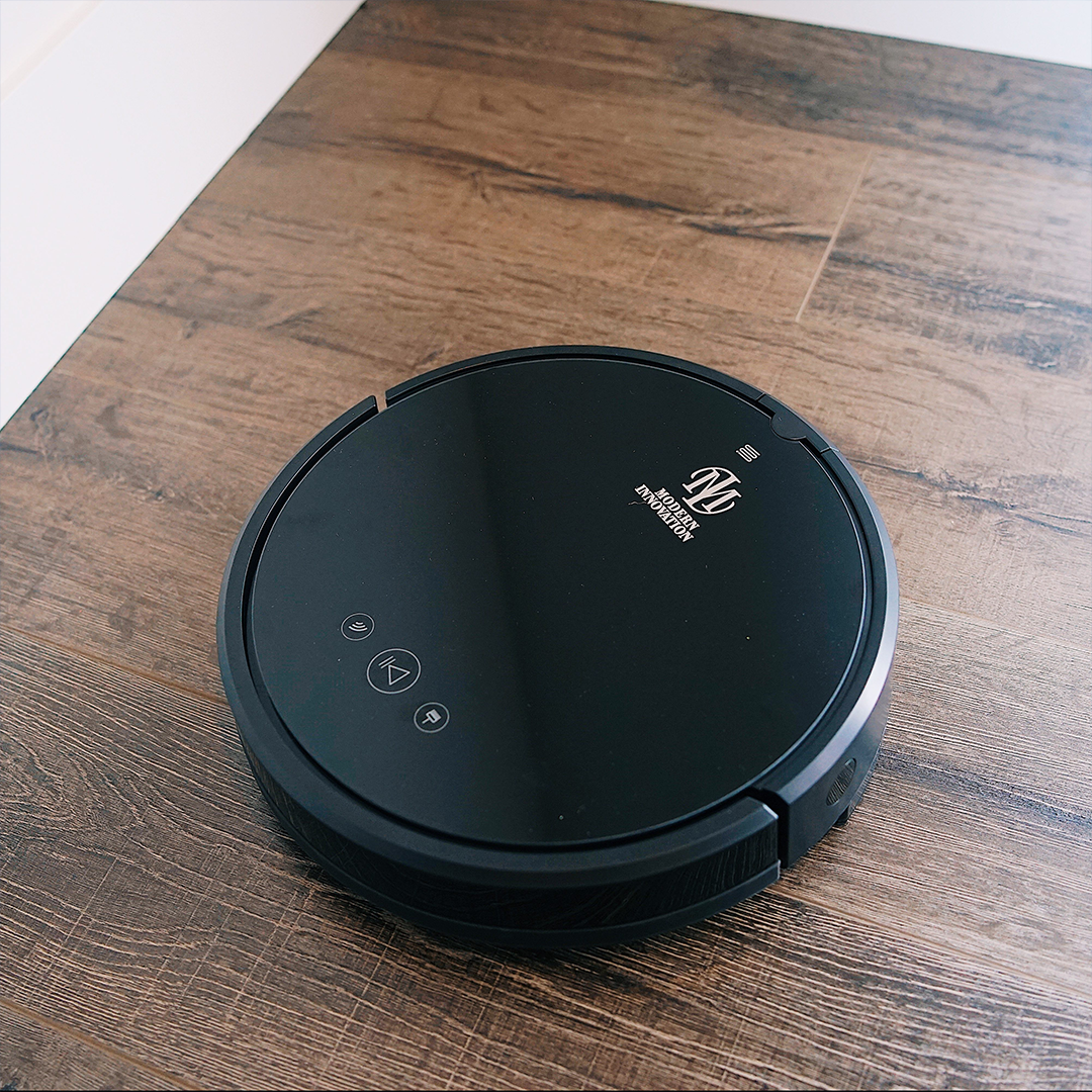 WiFi Robot Vacuum cleaning a hardwood floor, showcasing its sleek design and smart navigation features.