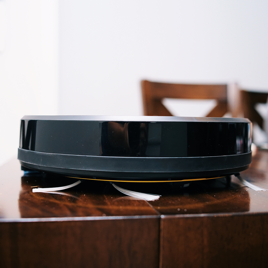 WiFi Robot Vacuum cleaning a hardwood floor, showcasing its sleek design and smart navigation features.