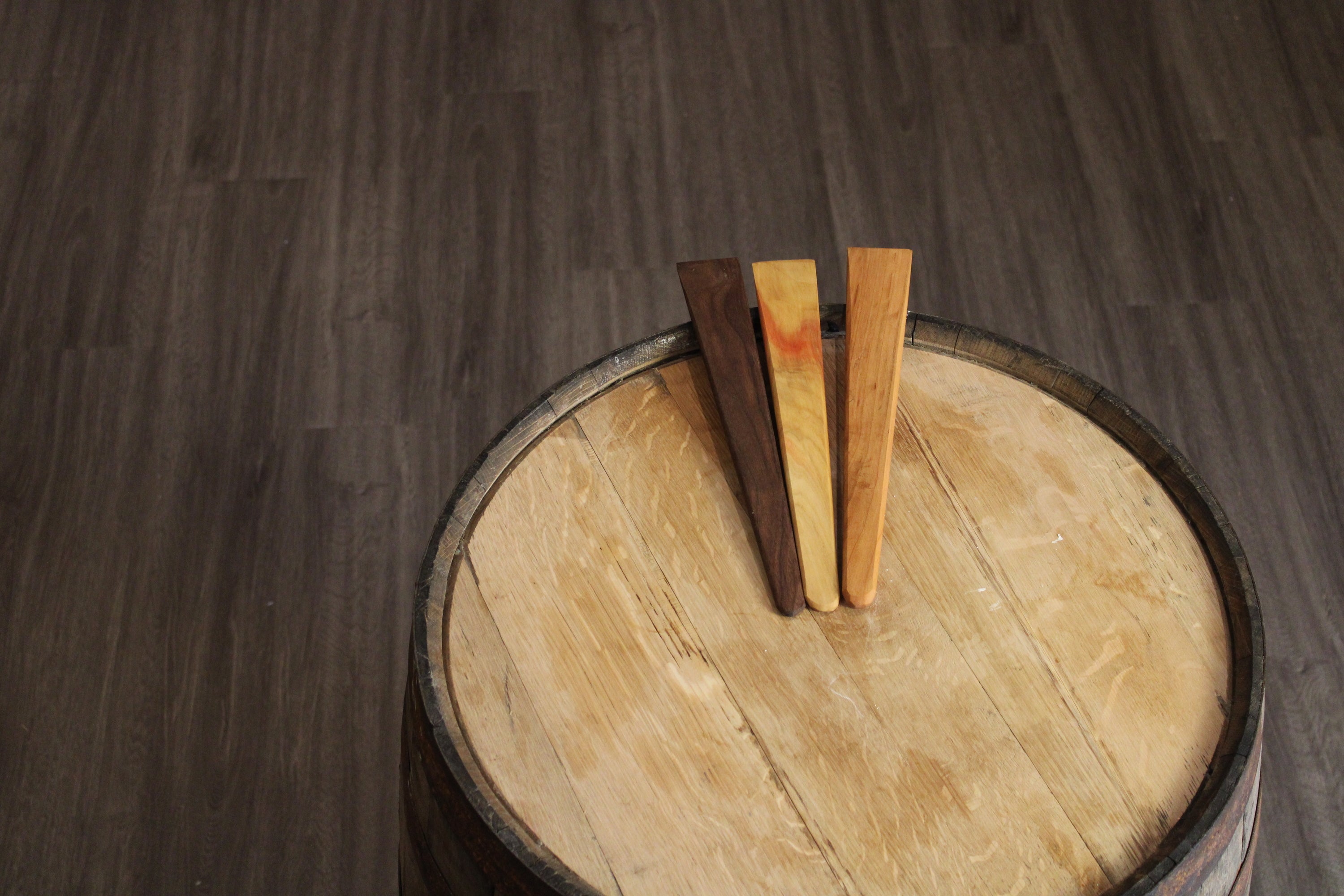 A 13-inch wooden spatula made from urban lumber, showcasing its thin design and beautiful wood grain in Cherry, Walnut, and Maple finishes.