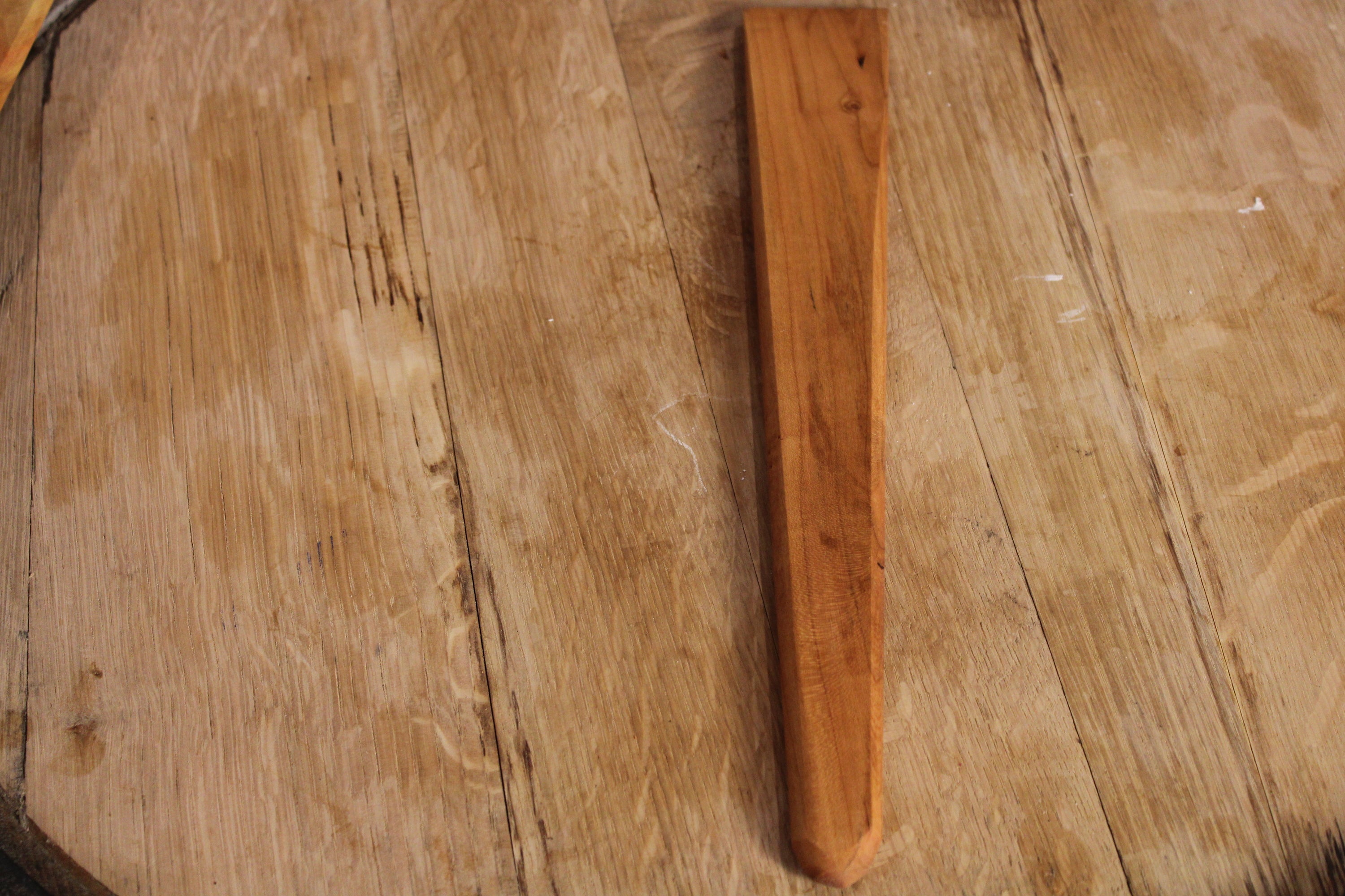 A 13-inch wooden spatula made from urban lumber, showcasing its thin design and beautiful wood grain in Cherry, Walnut, and Maple finishes.