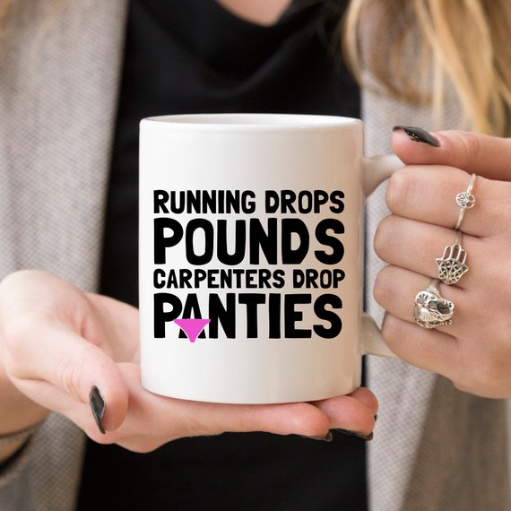 A humorous 11oz coffee mug featuring the phrase 'Running Drops Pounds, Carpenters Drop Panties' in a vibrant design.