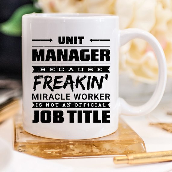 A humorous 11oz coffee mug featuring the phrase 'Unit Manager Because Freakin' Miracle Worker Is Not An Official Job Title' in a stylish font.