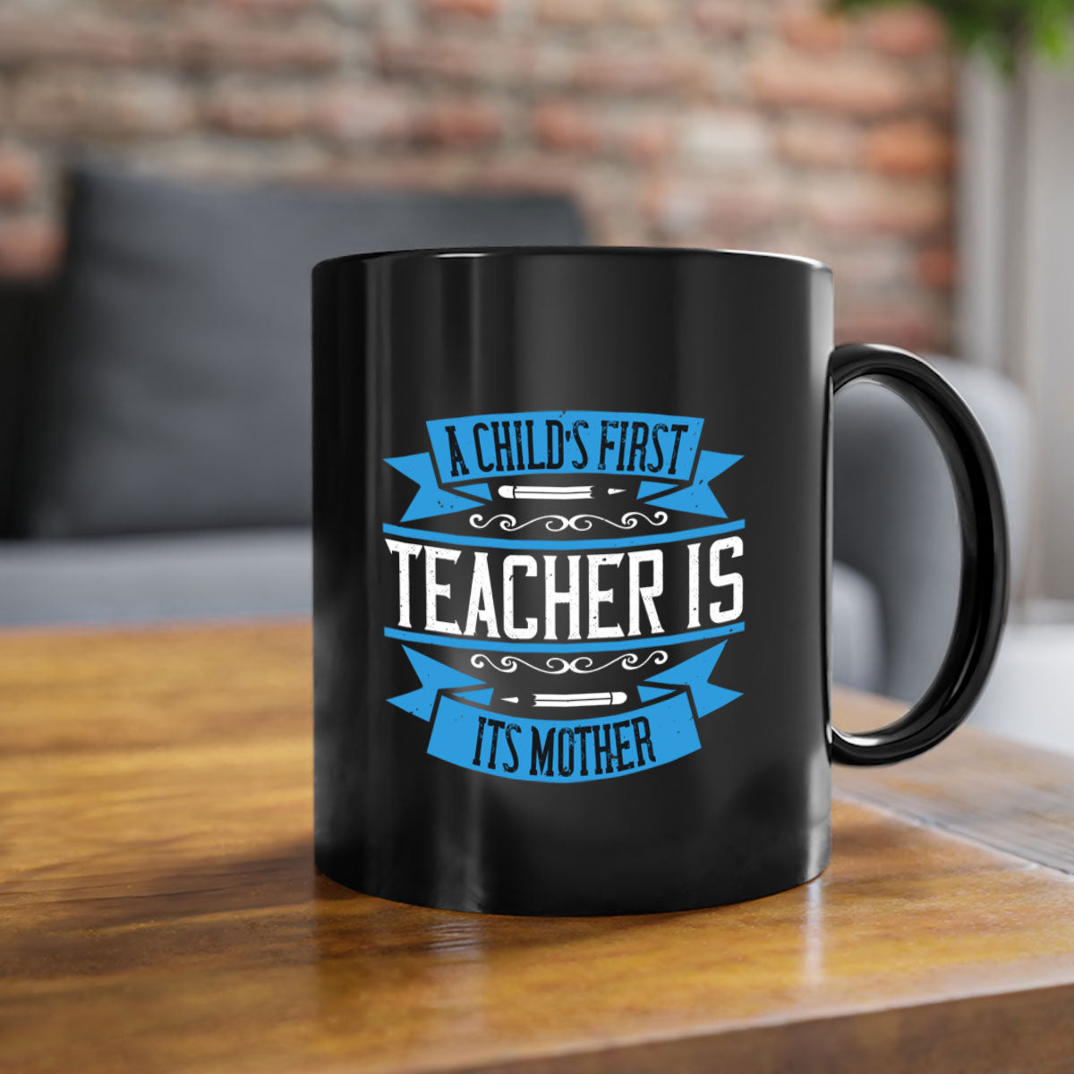 A stylish two-tone coffee mug with a colored handle and glossy finish, featuring the phrase 'A child’s first teacher is its mother'.