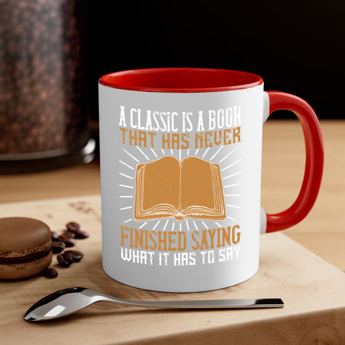 A two-tone ceramic mug featuring a colored handle and interior, showcasing the phrase 'A Classic is a Book That Has Never Finished Saying What It Has to Say'.