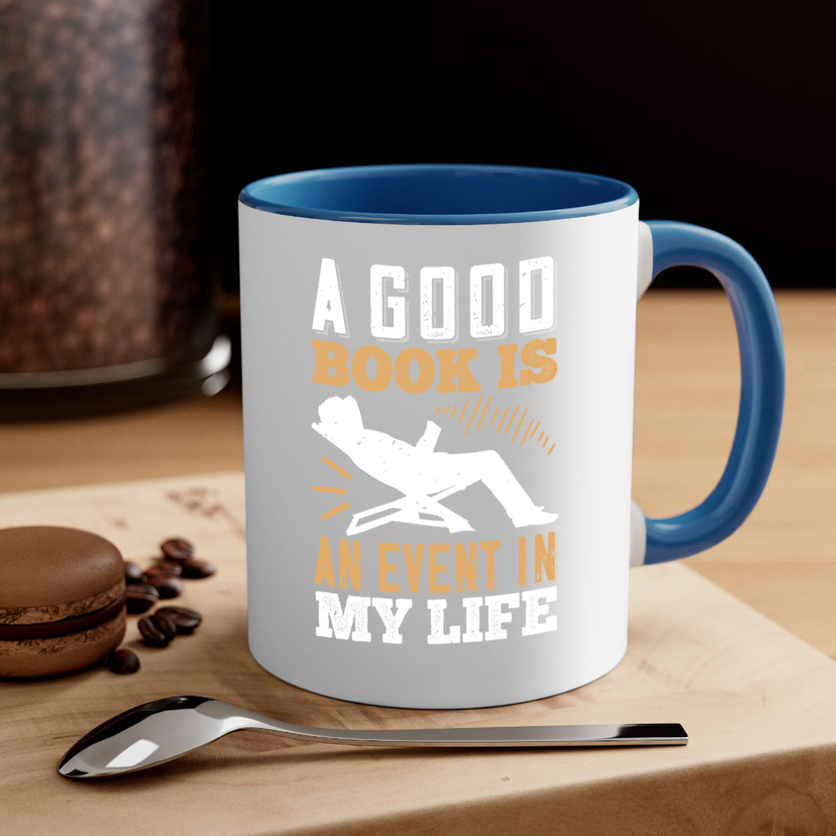 A stylish two-tone ceramic mug with a colored handle and interior, featuring the phrase 'A Good Book is an Event in My Life'.