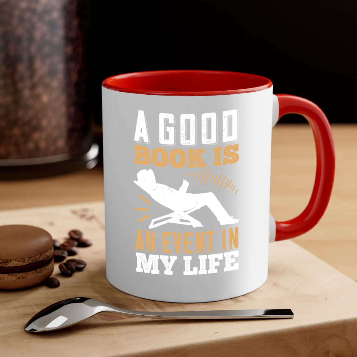 A stylish two-tone ceramic mug with a colored handle and interior, featuring the phrase 'A Good Book is an Event in My Life'.