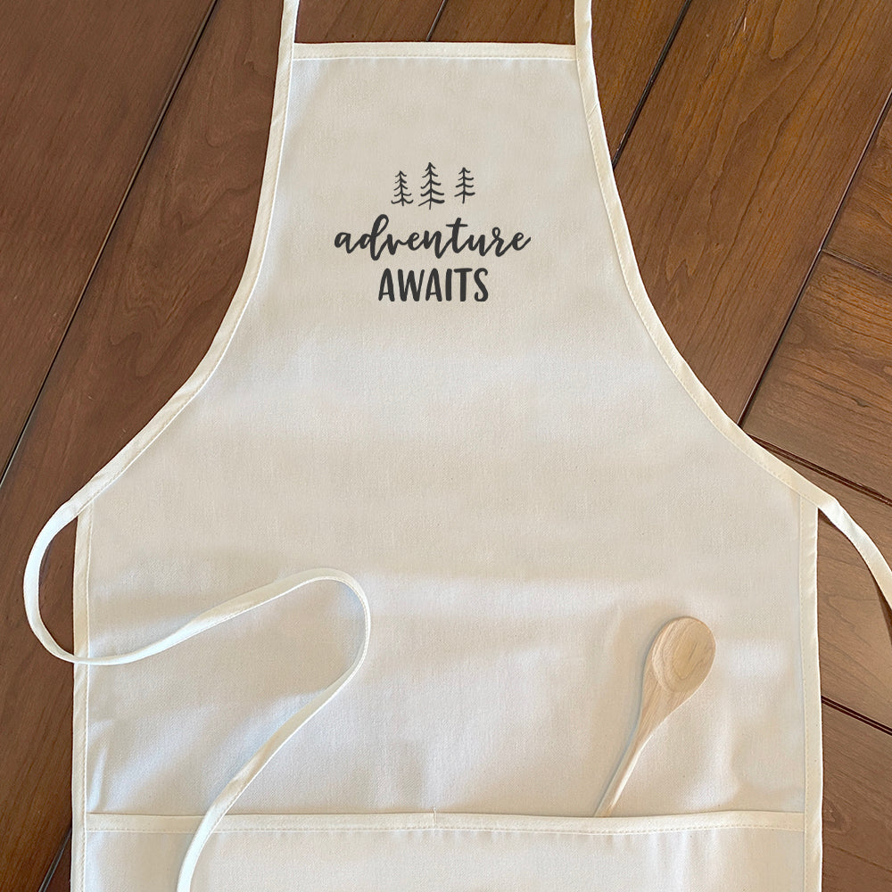 Adventure Awaits Women's Apron featuring a tree design, made of cotton canvas with adjustable neck and twill ties.