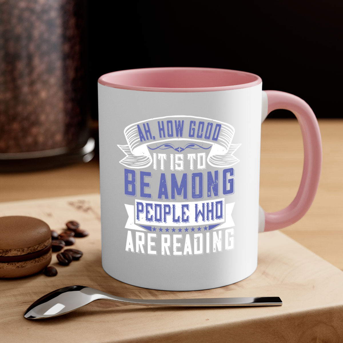 A stylish two-tone ceramic mug with a colored handle and interior, featuring the phrase 'ah how good it is to be among people who are reading 77#'.