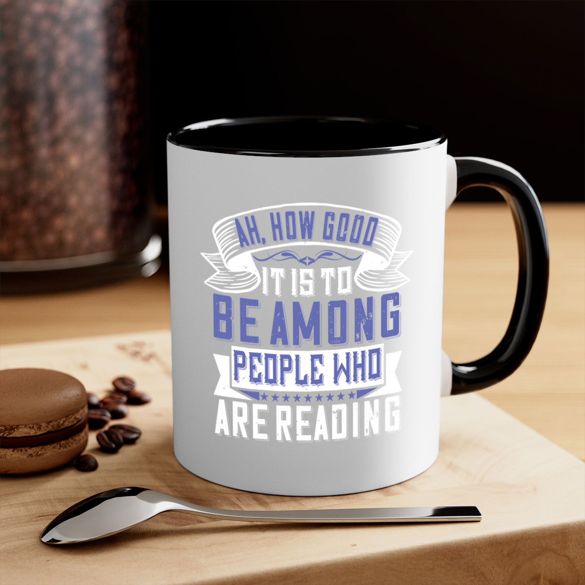 A stylish two-tone ceramic mug with a colored handle and interior, featuring the phrase 'ah how good it is to be among people who are reading 77#'.