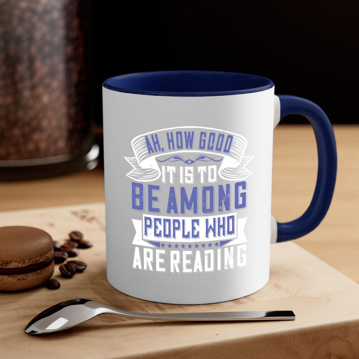 A stylish two-tone ceramic mug with a colored handle and interior, featuring the phrase 'ah how good it is to be among people who are reading 77#'.