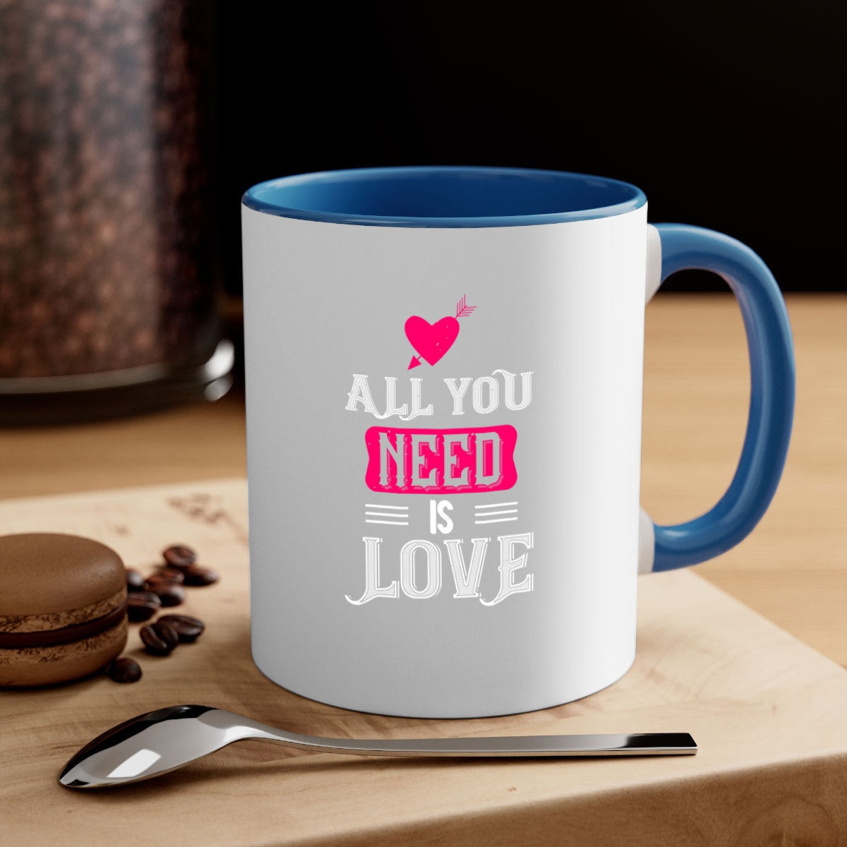 A stylish two-tone 'All You Need Is Love' mug with a glossy finish, featuring a colored handle and interior, perfect for coffee or tea.