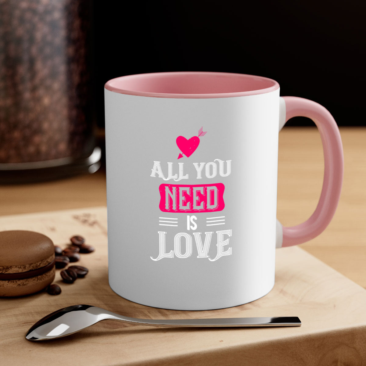 A stylish two-tone 'All You Need Is Love' mug with a glossy finish, featuring a colored handle and interior, perfect for coffee or tea.