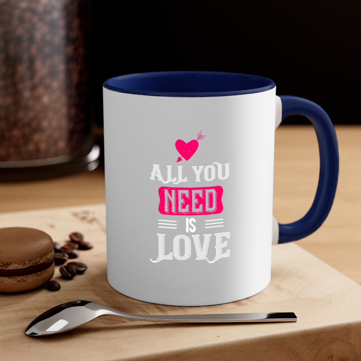 A stylish two-tone 'All You Need Is Love' mug with a glossy finish, featuring a colored handle and interior, perfect for coffee or tea.