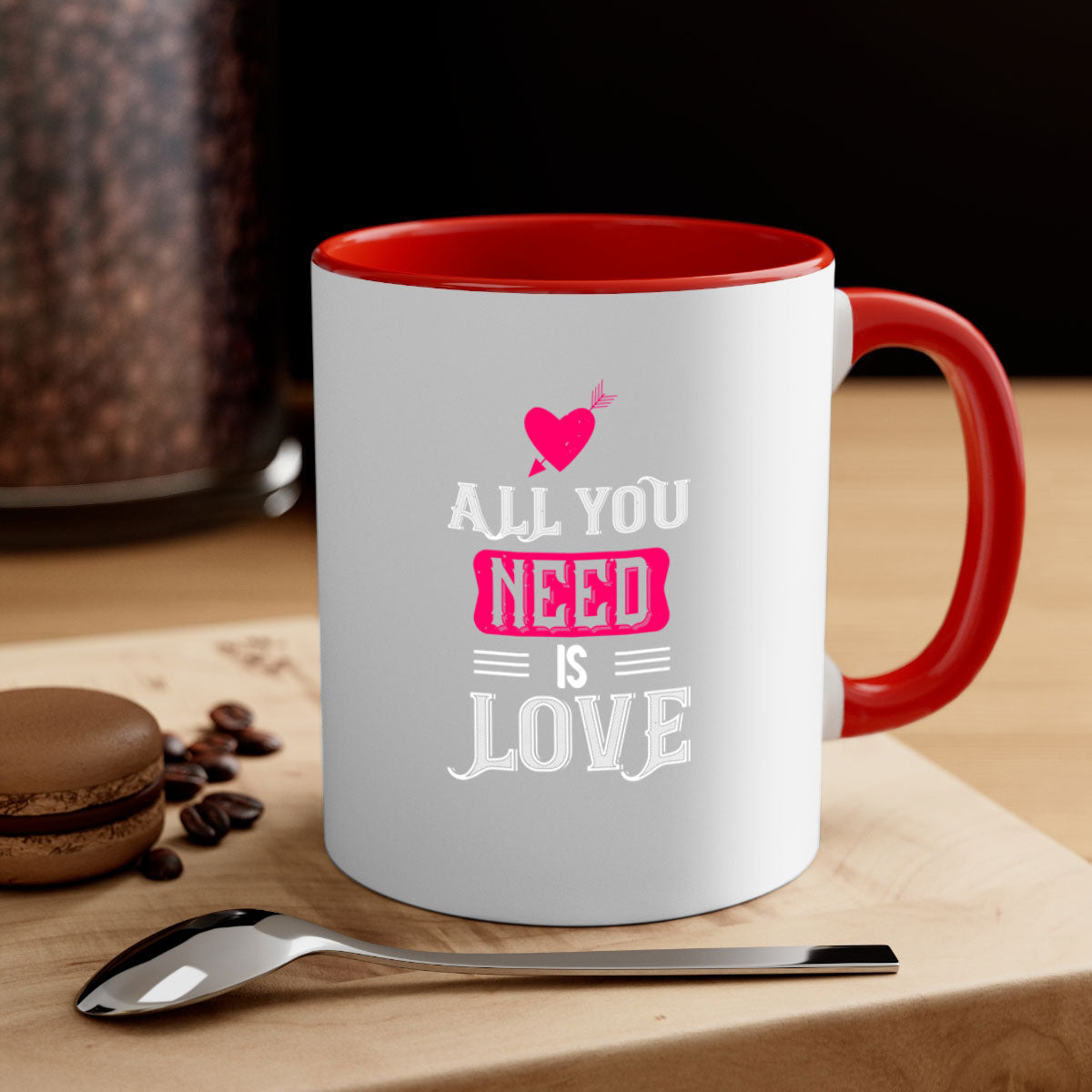 A stylish two-tone 'All You Need Is Love' mug with a glossy finish, featuring a colored handle and interior, perfect for coffee or tea.