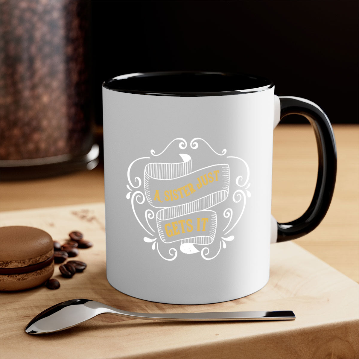 Two-tone ceramic coffee mug with colorful handle and interior, featuring the phrase 'All You Need Is Love… and a Sister'.