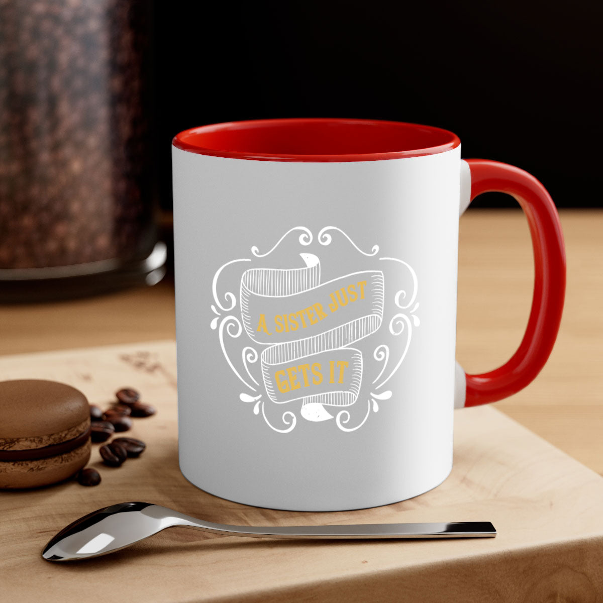 Two-tone ceramic coffee mug with colorful handle and interior, featuring the phrase 'All You Need Is Love… and a Sister'.