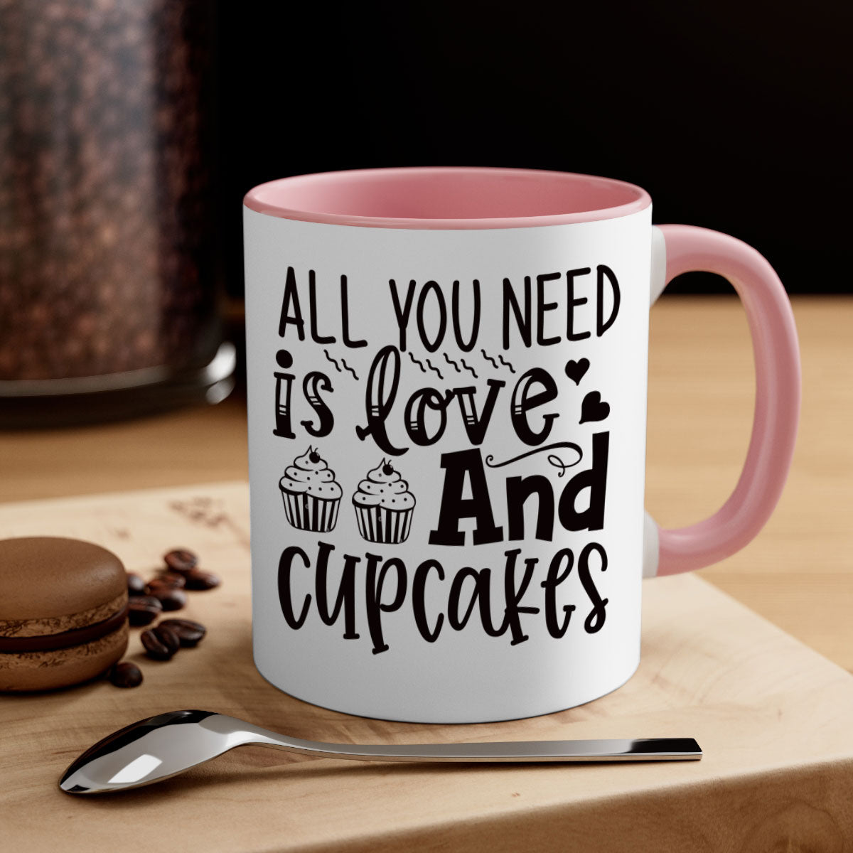 A colorful two-tone ceramic mug with the phrase 'All You Need Is Love and Cupcakes' printed on it, featuring a glossy finish and a C-shaped handle.