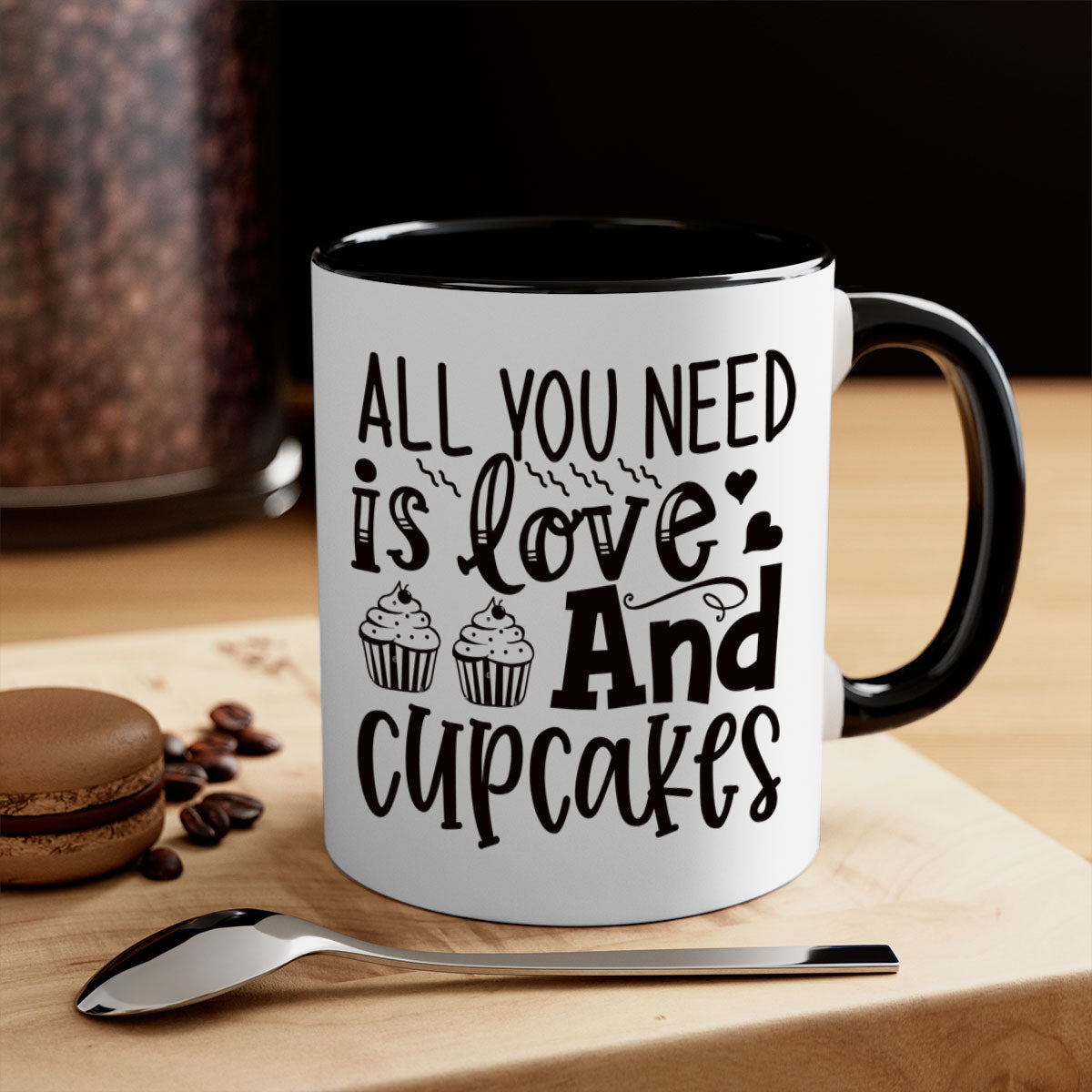 A colorful two-tone ceramic mug with the phrase 'All You Need Is Love and Cupcakes' printed on it, featuring a glossy finish and a C-shaped handle.