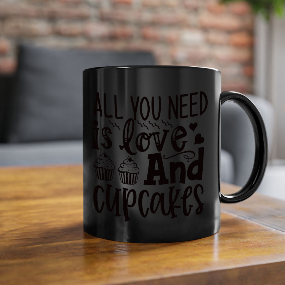 A colorful two-tone ceramic mug with the phrase 'All You Need Is Love and Cupcakes' printed on it, featuring a glossy finish and a C-shaped handle.