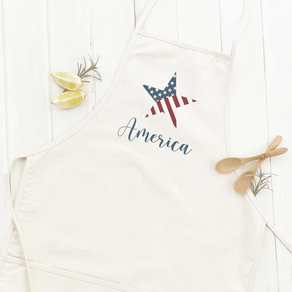 America Star Women's Apron in cotton canvas with natural twill ties and front pocket, showcasing its elegant design.