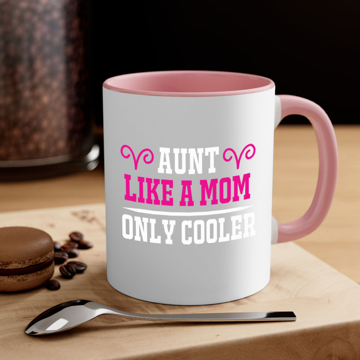 A stylish two-tone coffee mug with a colored handle and glossy finish, featuring the text 'Aunt Like a Mom Only Cooler'.