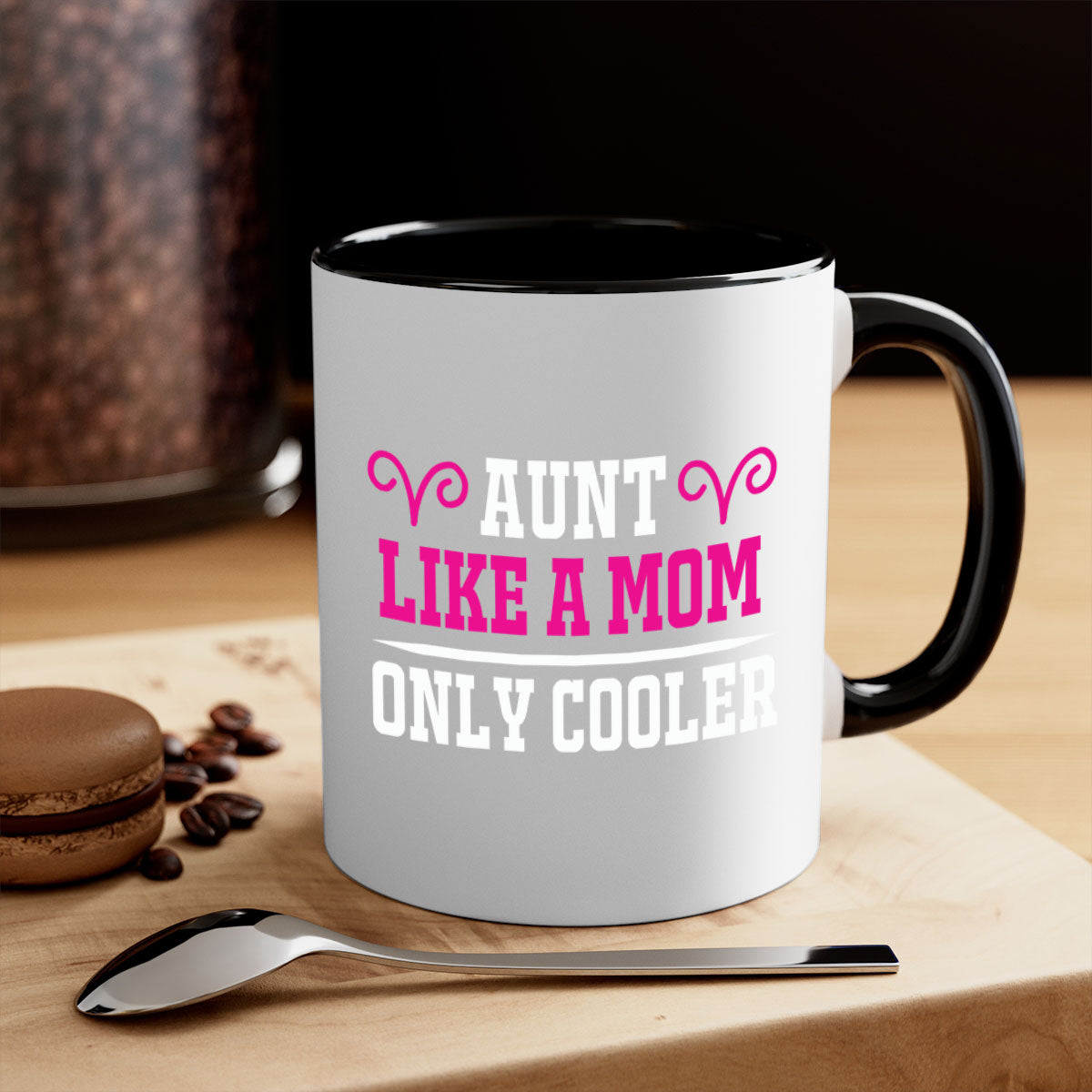 A stylish two-tone coffee mug with a colored handle and glossy finish, featuring the text 'Aunt Like a Mom Only Cooler'.