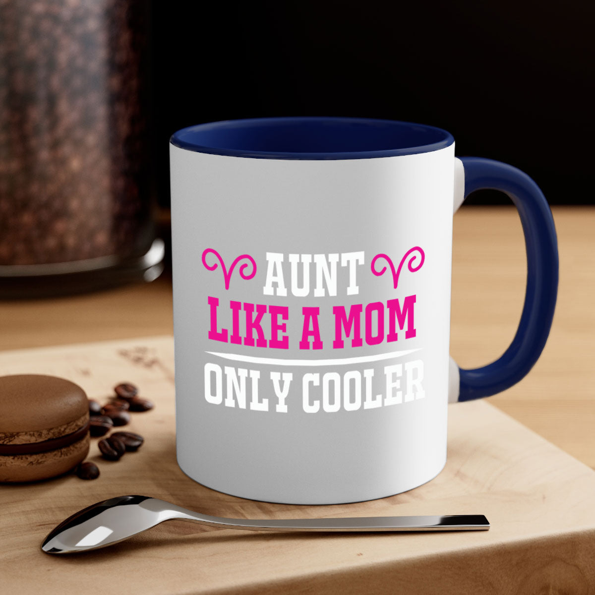 A stylish two-tone coffee mug with a colored handle and glossy finish, featuring the text 'Aunt Like a Mom Only Cooler'.