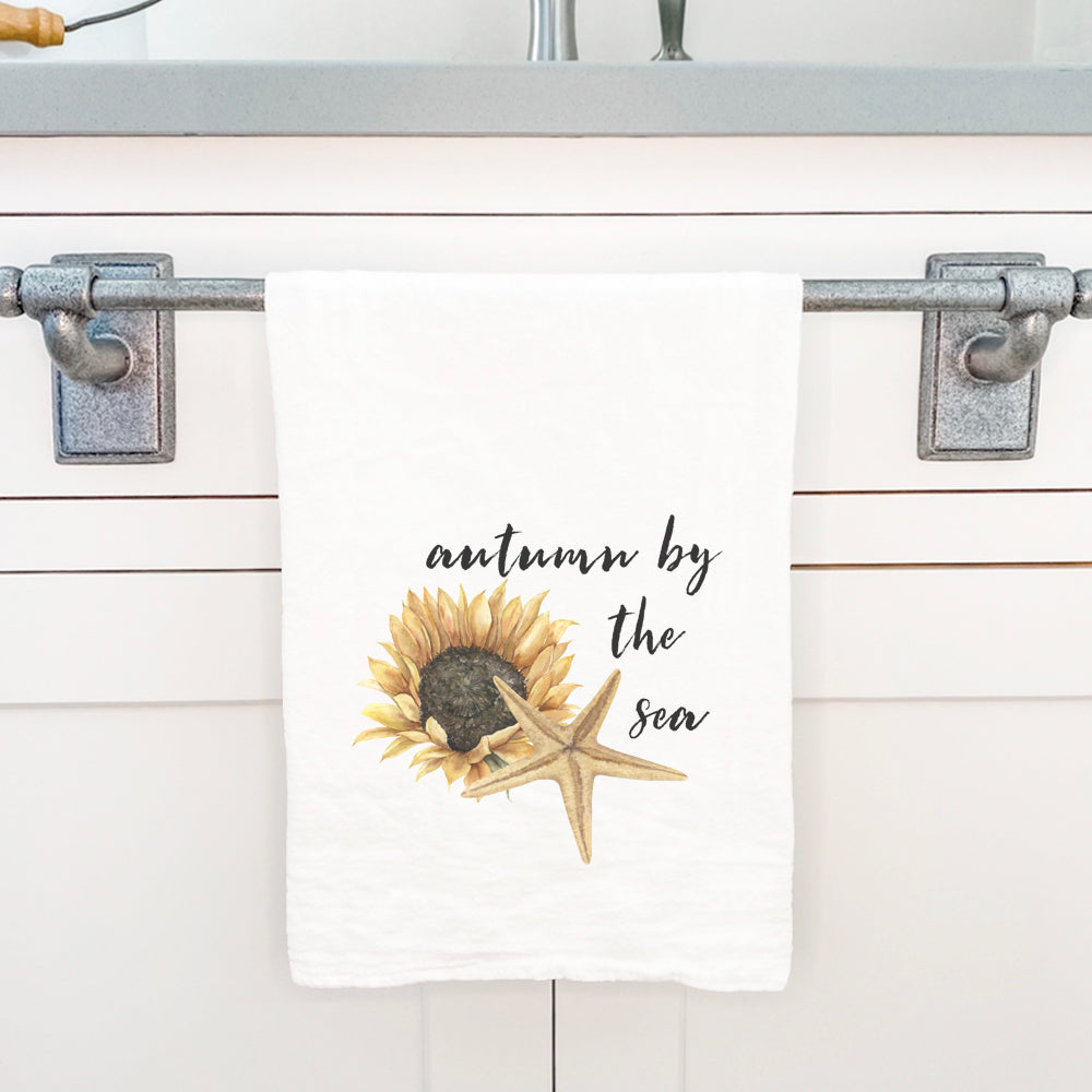 Autumn by the Sea cotton tea towel featuring vibrant colors and a beautiful design, perfect for kitchen use.